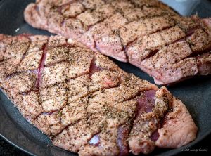 Duck breasts with orange-rum sauce seasoned cross cut