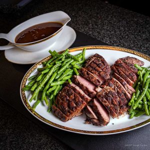 Duck breasts with orange-rum sauce crispy haricot verts serving