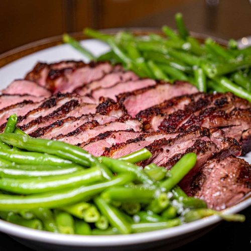 Duck breasts with orange-rum sauce haricot verts crispy